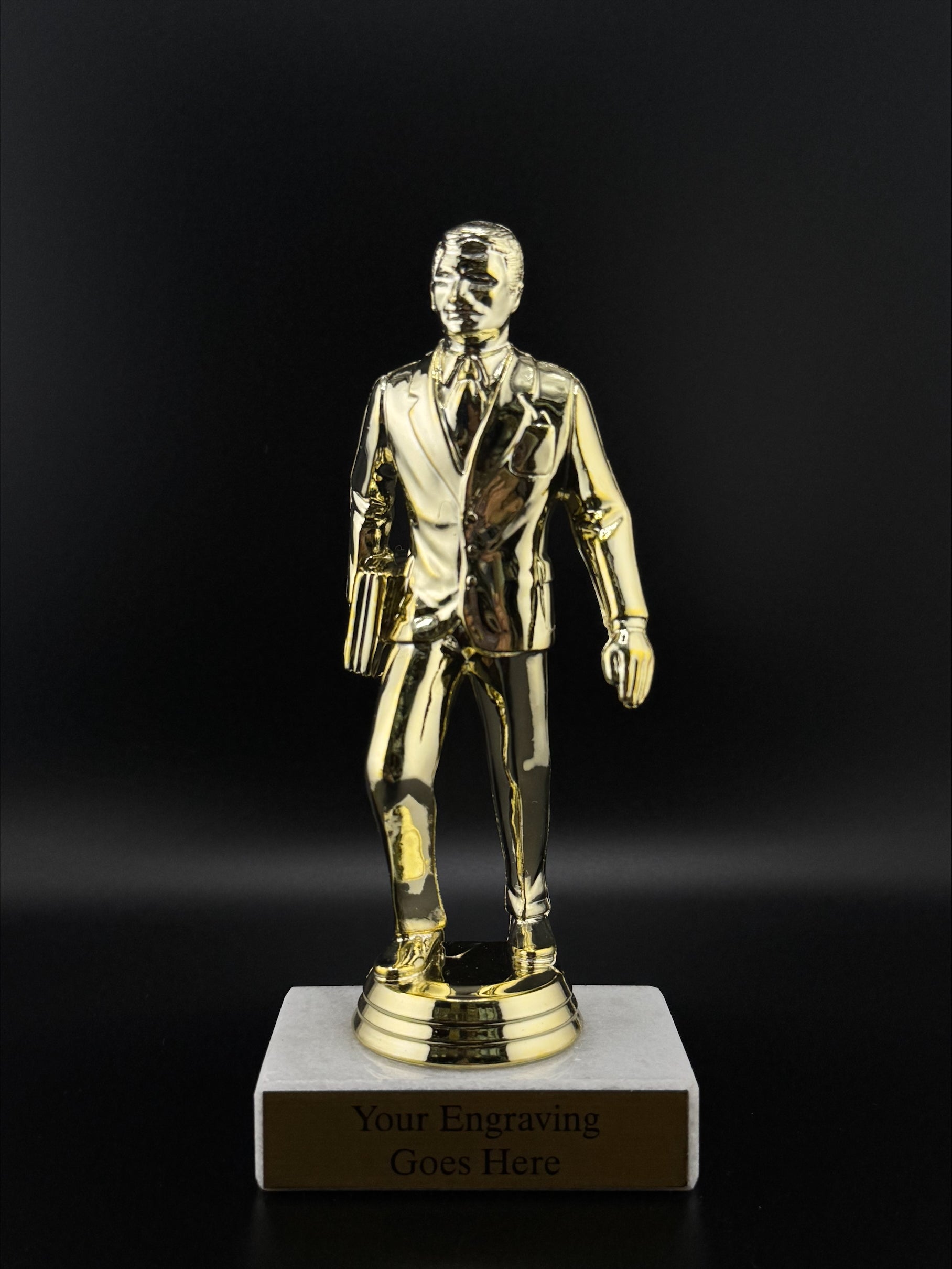 Gold trophy figure on a black background